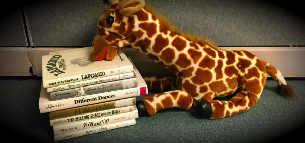 stack of books and stuffed giraffe