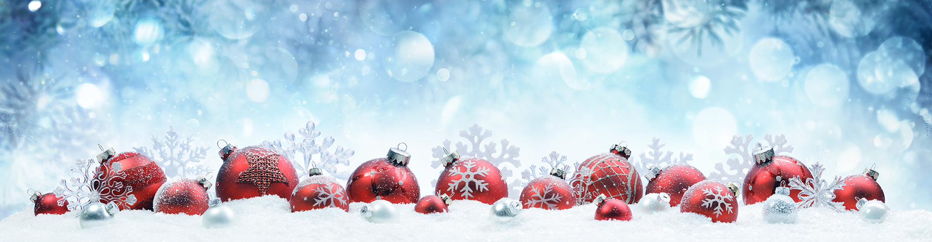 red christmas ornaments on a bed of snow