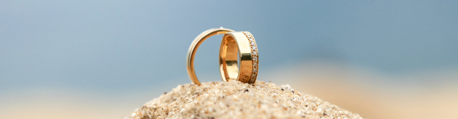 wedding rings posed on a beach