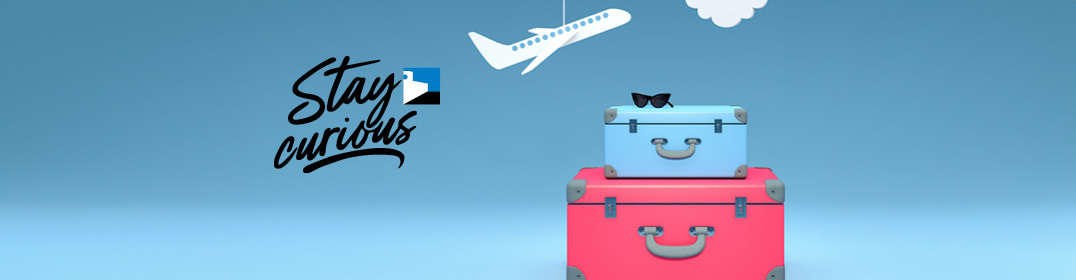 packed bags and a paper airplain on a blue background