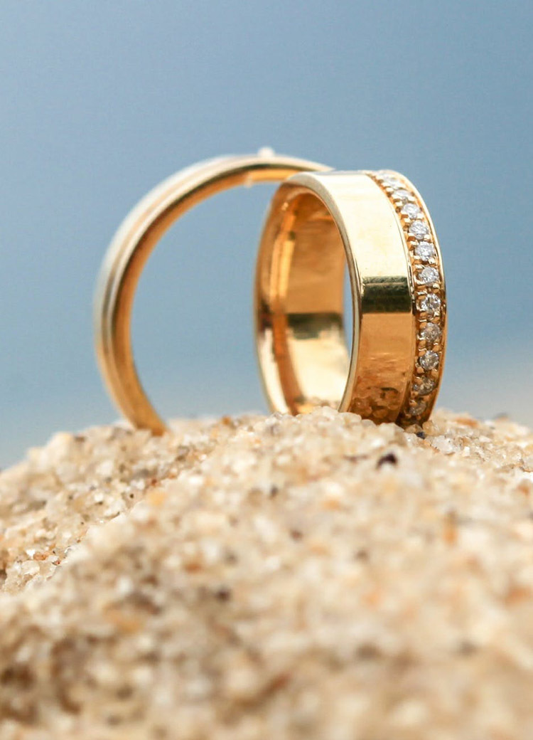 wedding rings posed on a beach