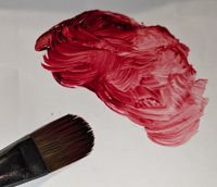 red oil paint and brush