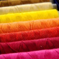 sewing thread in pink, red, orange, yellow
