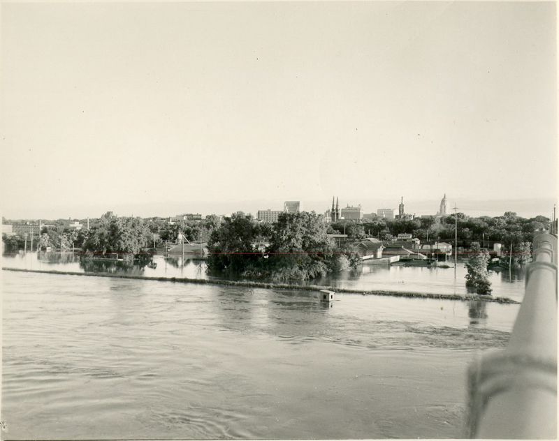 A black and white photo showing a view of North Topeka looking towards downtown; everything that can be seen is underwater
