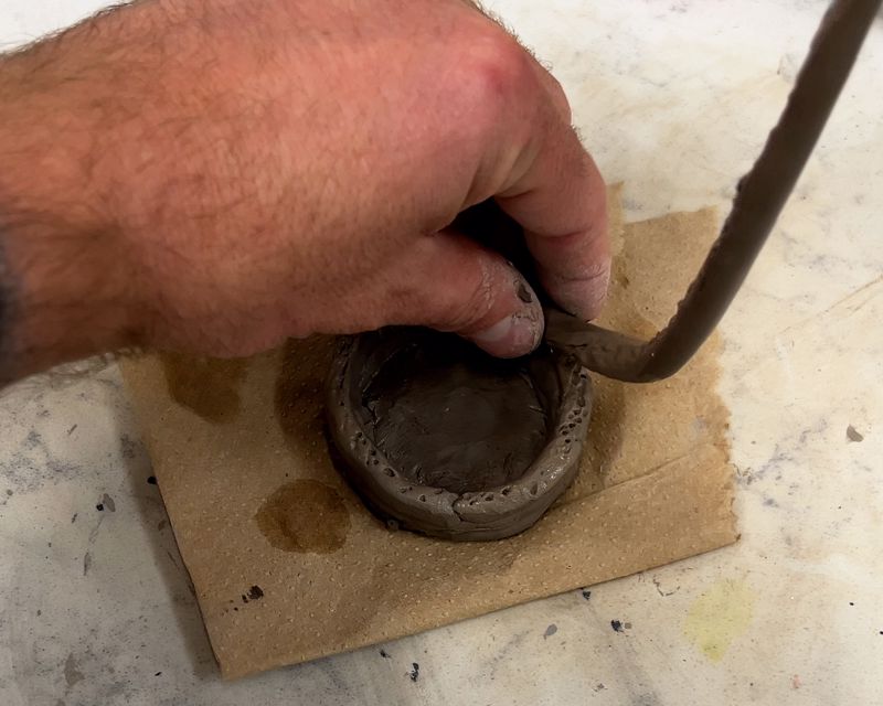 Adding coils on top of another coil to build the pot walls up.