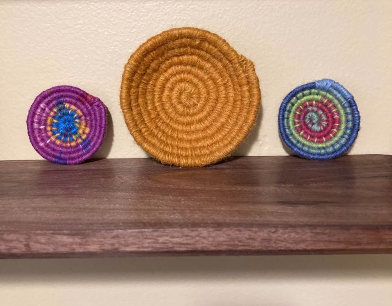 three coiled yarn baskets on a shelf