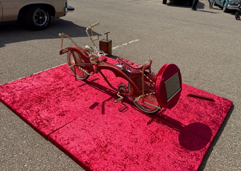 red lowrider bike on red carpet