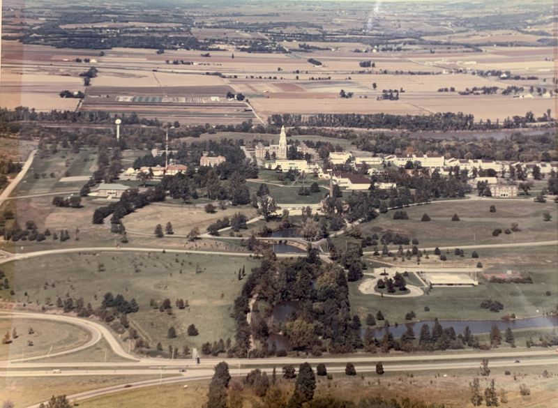 Color photo of an aerial view of the Menninger west campus with the clock tower in the center