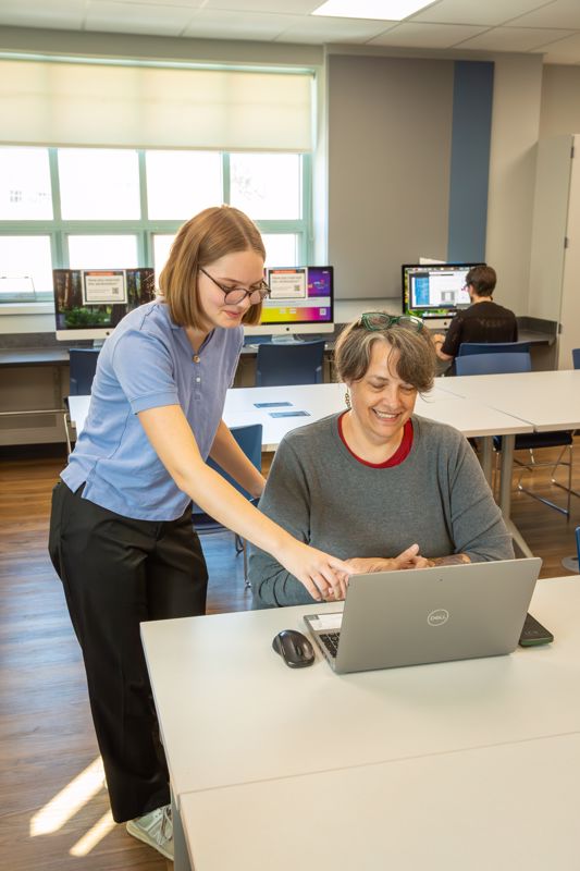 Emma helps at Gadget Help class