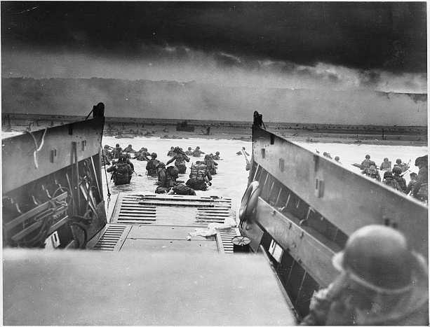 Black and white image showing men going ashore on D-Day