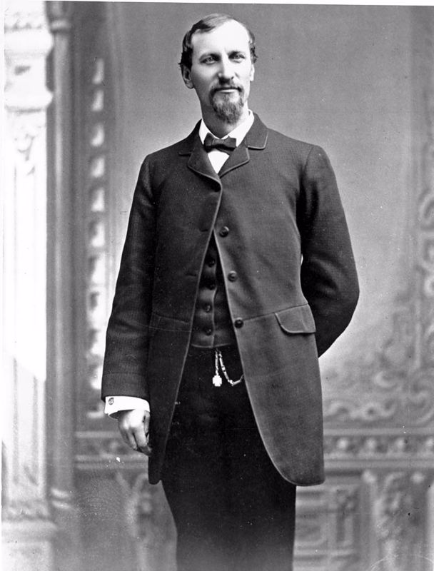 A black and white full body portrait of Fred Harvey