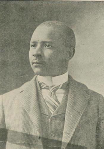 Black and white portrait of Nick Chiles wearing a suit and tie