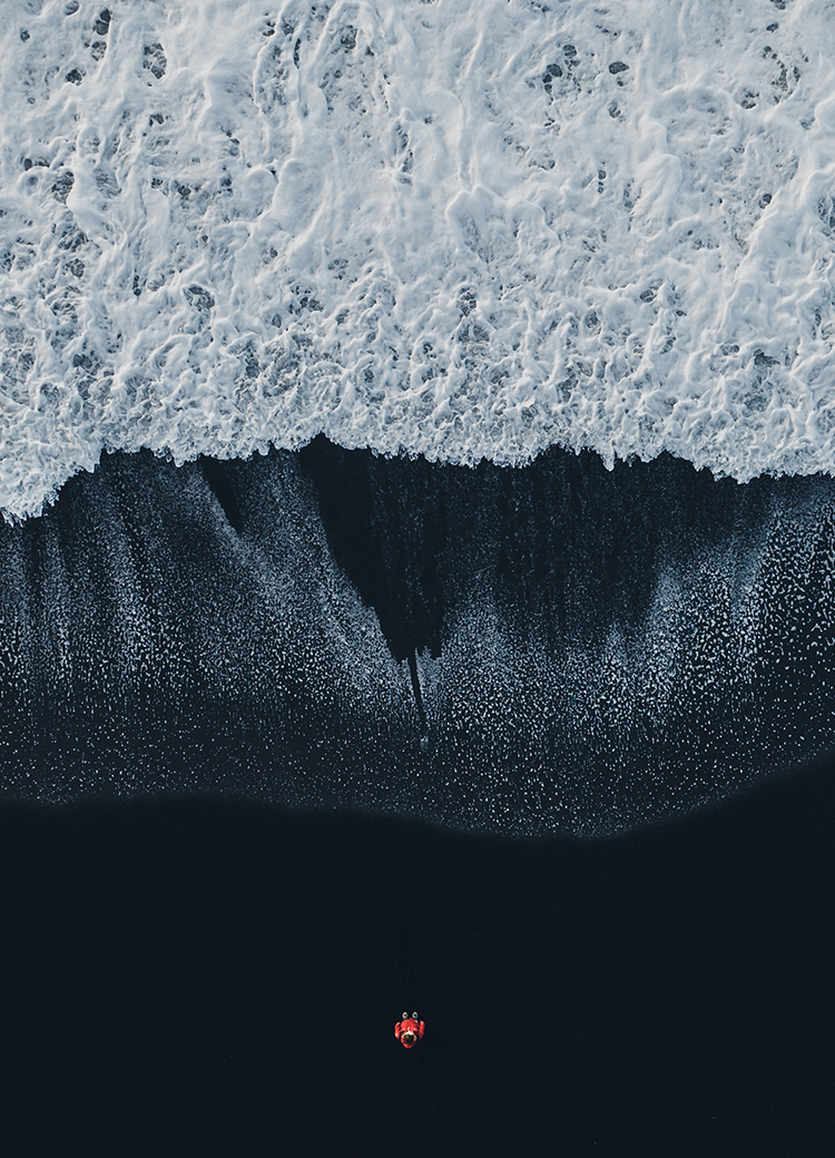 black beach with a tiny person