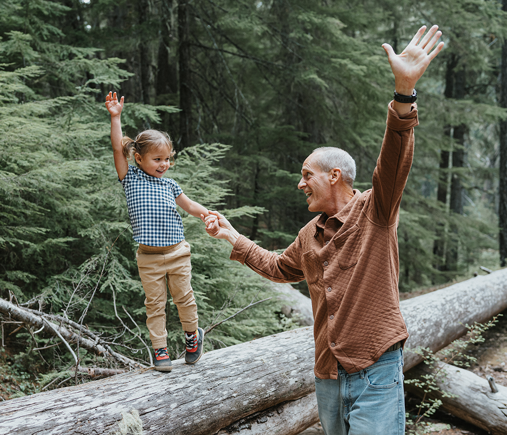 girl and grandpa playing in the woods