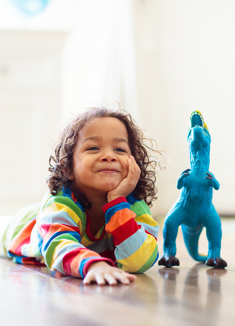 kid with toy dinosaur