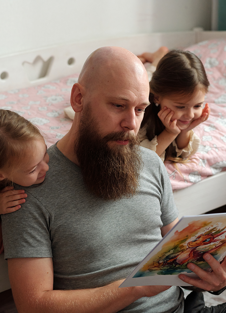 dad reading to daughters