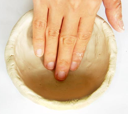 Pressing the bottom to a flat surface.
