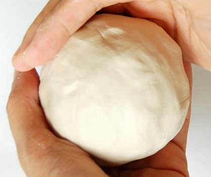 Rolled ball of clay to start pinch pot.