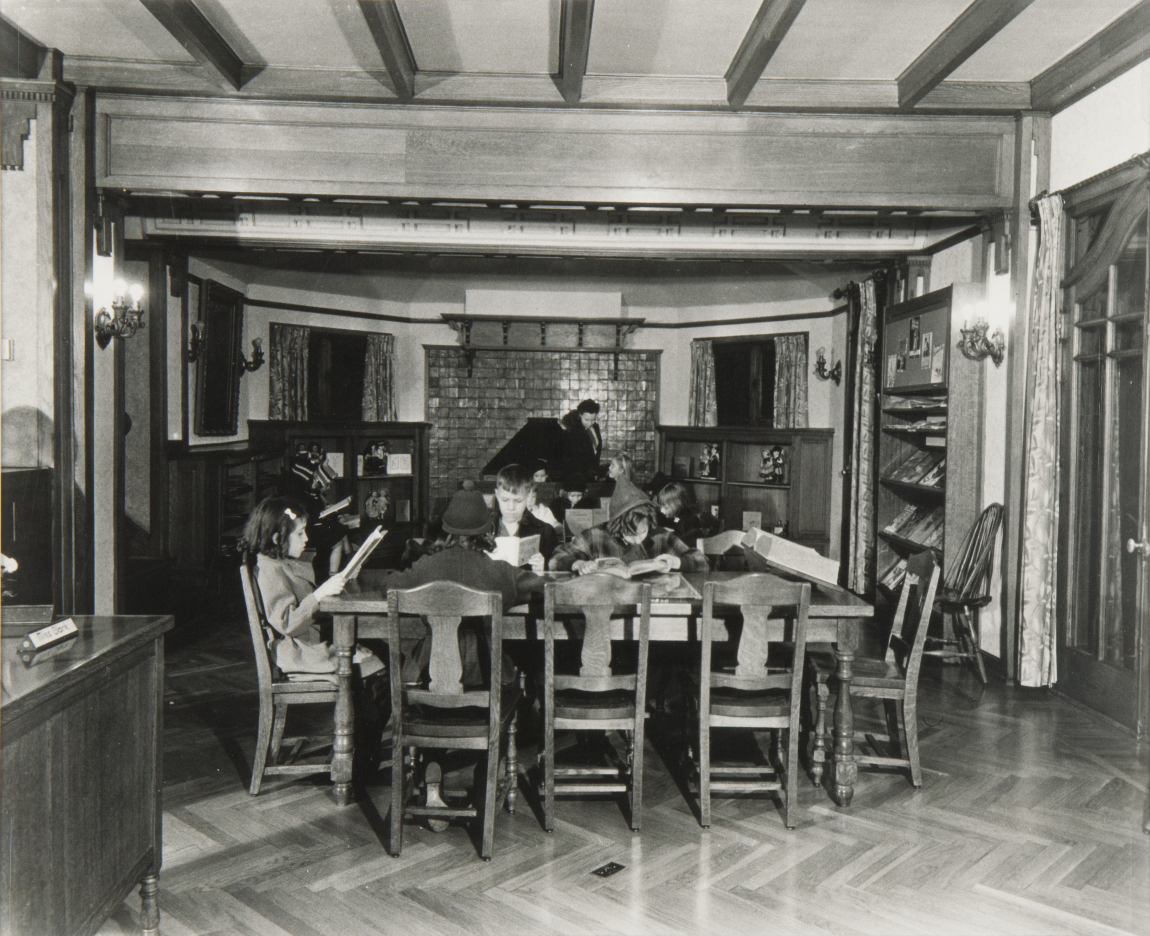 kids reading at table in 1940s