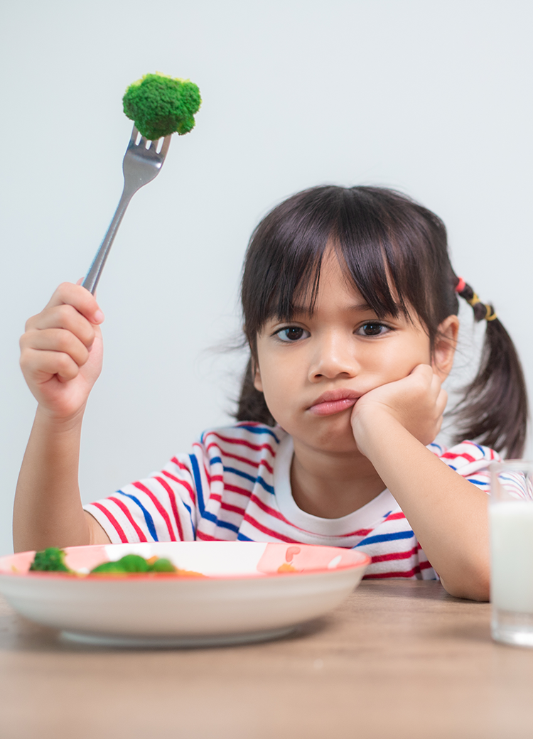 kid frowning at food