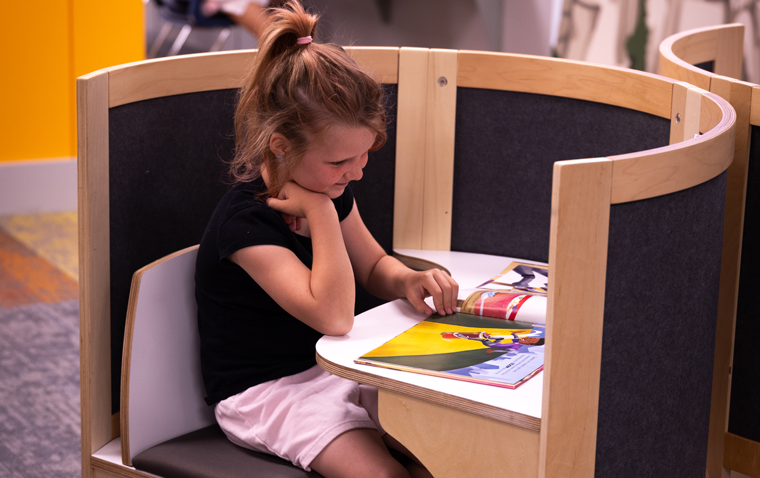 Girl Reading in Kids Library