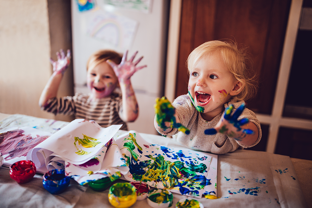 2 young kids finger painting