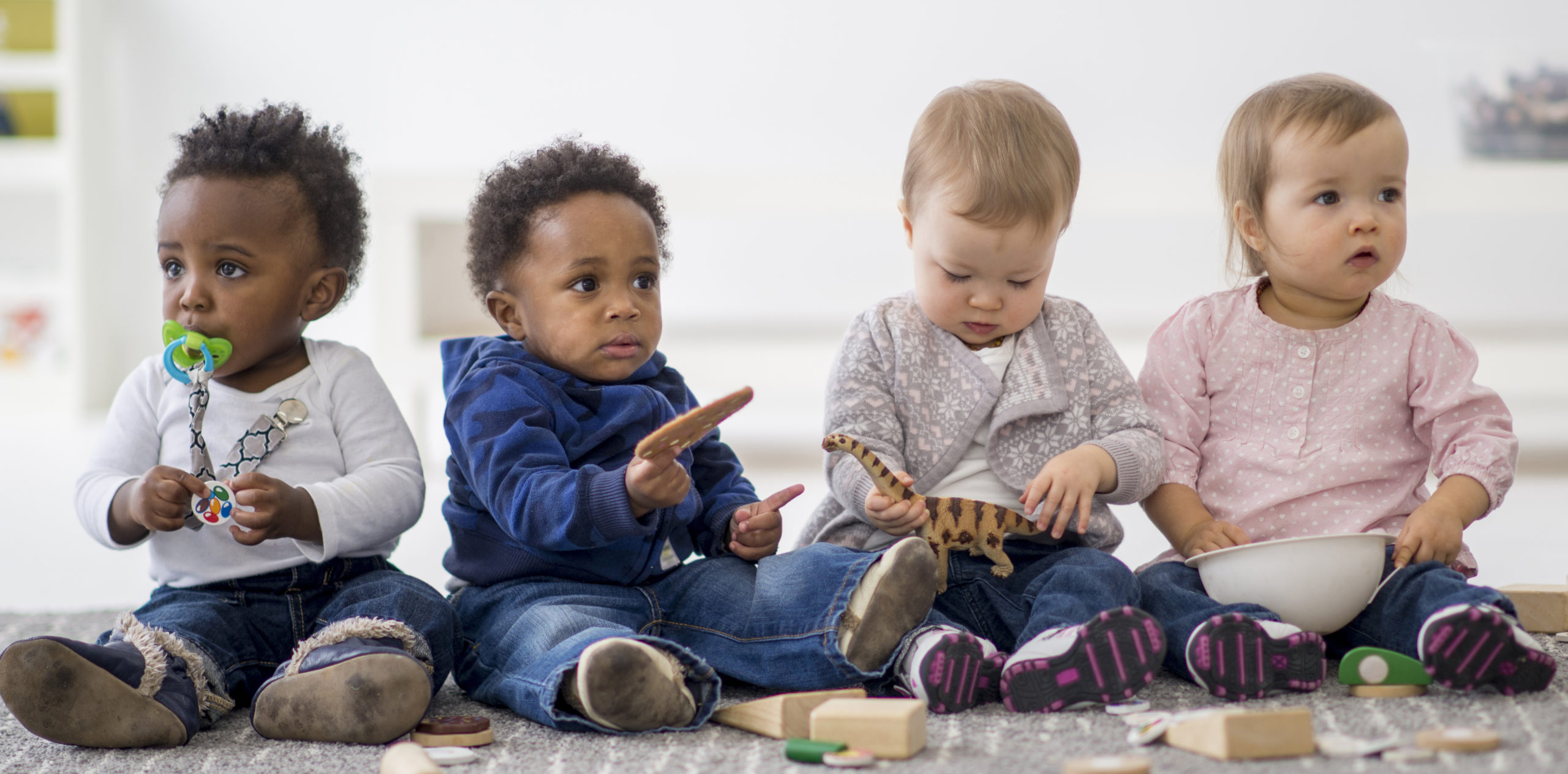 group of toddlers playing together with toys