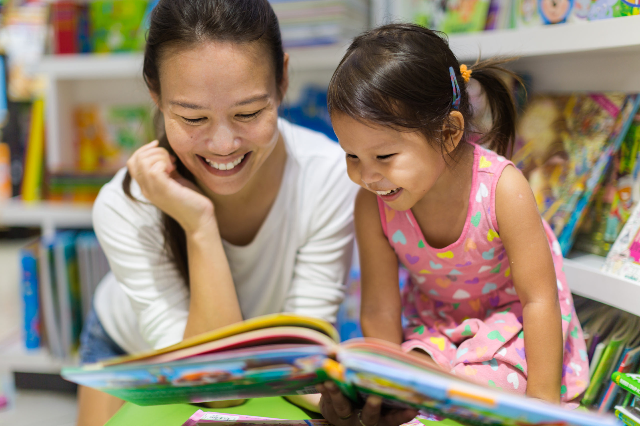mother and young daughter reading