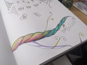 Julie's art journal page updated with rainbow colors on the branch and the words "Bee Brilliant" written underneath