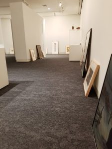 framed prints leaned against walls