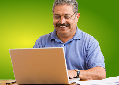 man happily working at computer