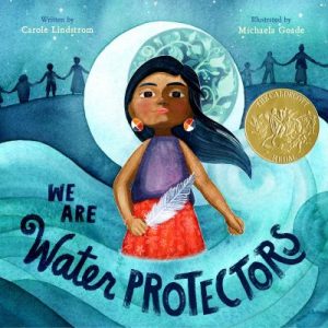 We are water Protectors book cover. Features a Sioux girl in purple and read, holding a feather. She is surrouned by water and the crescent moon is behind her.