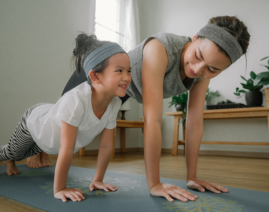 mother and daughter doing yoga