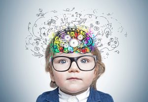 toddler with colorful brain sketch with cogs drawn inside his head. Concept of thinking