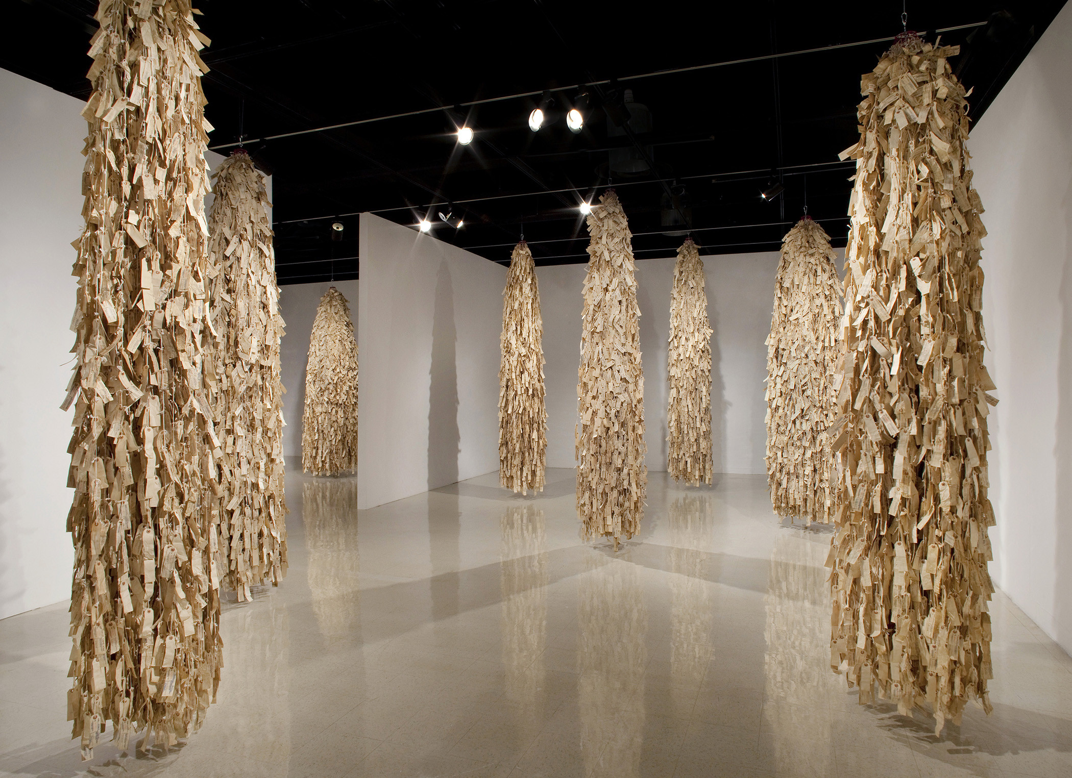large hanging sculptures made from hundreds of name tags