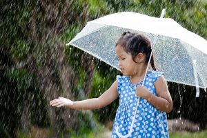 girl playing in rain