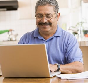 Man with laptop smiling 