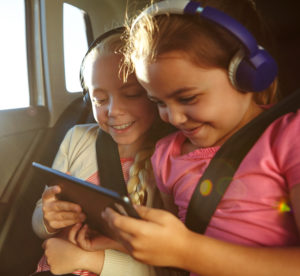 girls wearing headphones with a electronic tablet