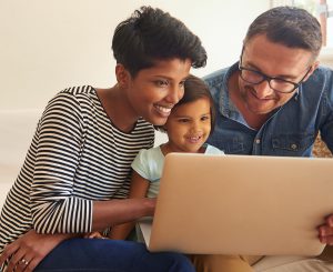 parents and child using computer