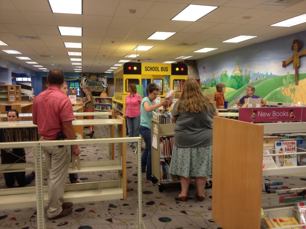 Library staff members load books onto carts