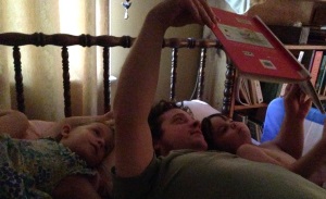 Daddy reading to kids
